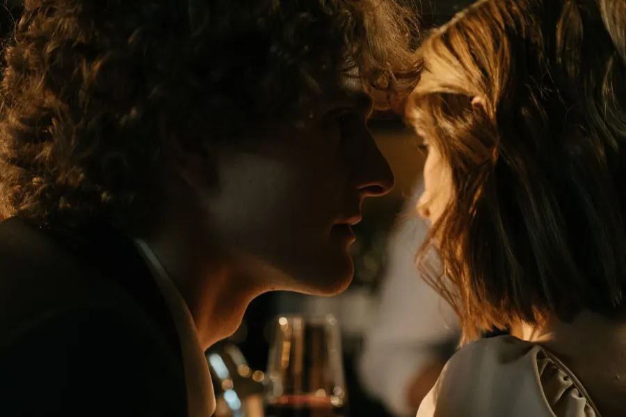Couple about to kiss in a dimly lit bar
